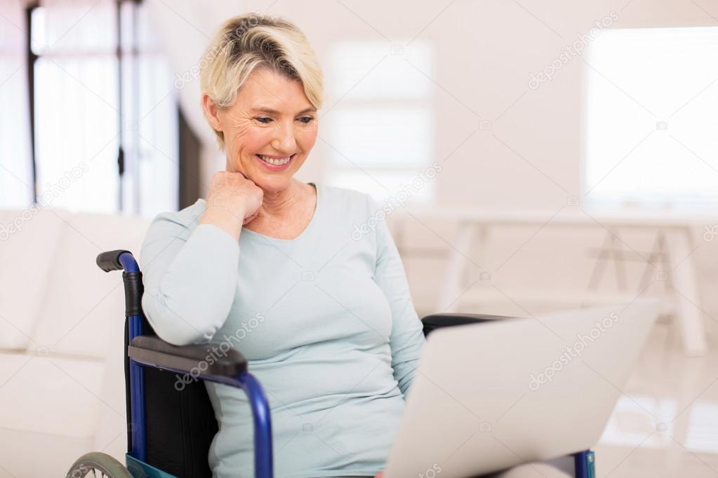 woman in wheelchair using laptop
