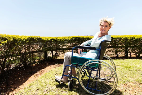 Disabled woman sitting outdoors — Stock Photo, Image