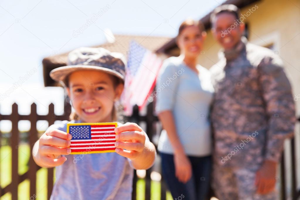 girl holding american flag badge