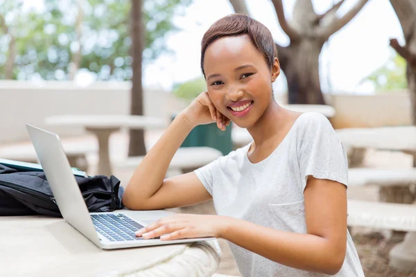 Жіночий африканський студент, що працює на ноутбуці — стокове фото