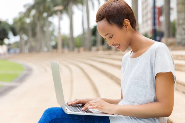 Student with laptop sitting outdoors — Stock Photo, Image