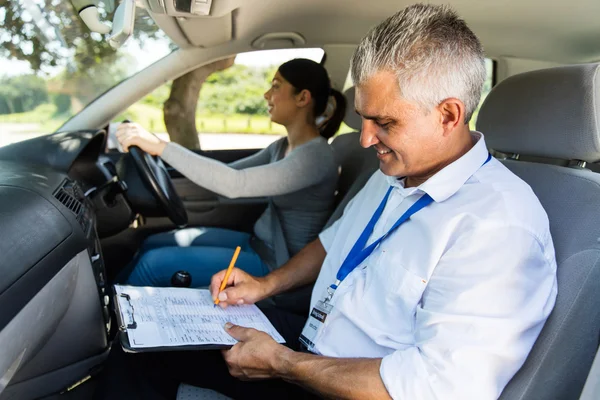 Girl taking driving test with instructor — Stock Photo, Image