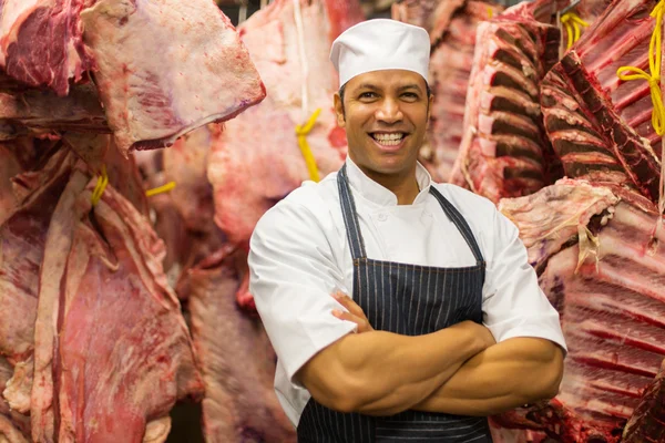 Butcher standing in storage room — Stock Photo, Image