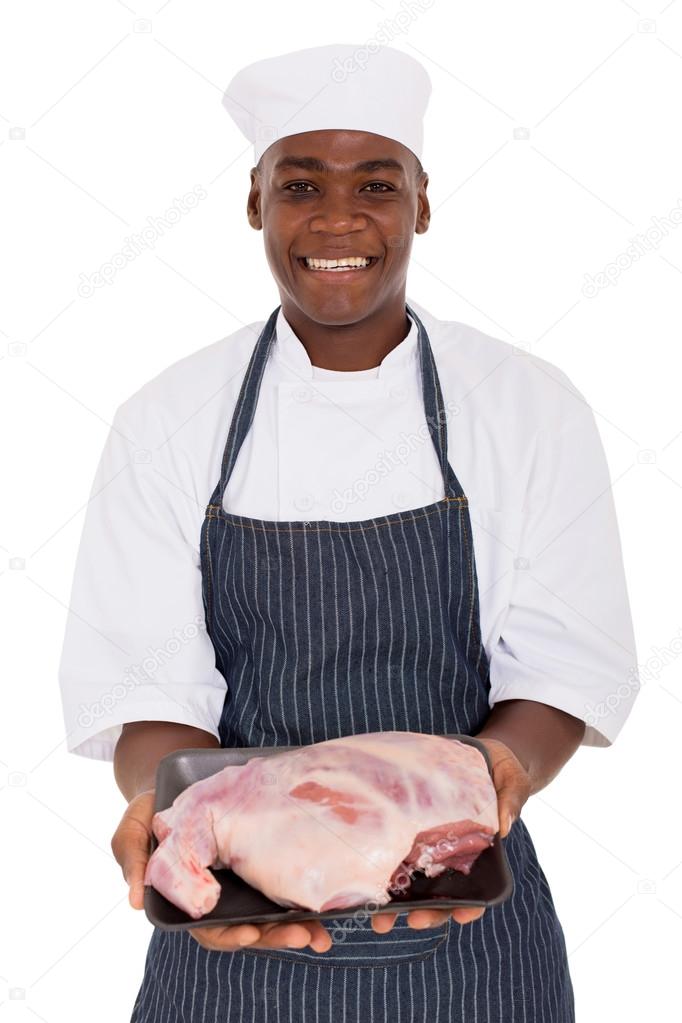 butcher holding raw meat
