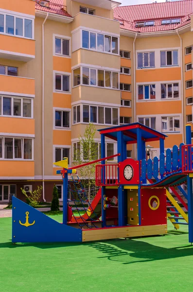 New colorful children's play complex in the courtyard of a multi