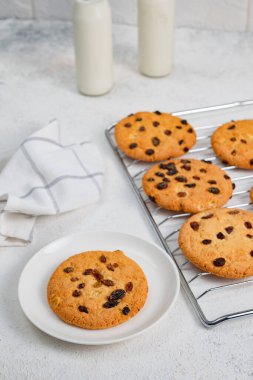 Ev yapımı hamur işleri, büyük kuru üzümlü bisküviler. Çocuklar için ikramlar, doğal ürünlerden yapılan tatlılar. Kurabiye ve süt.