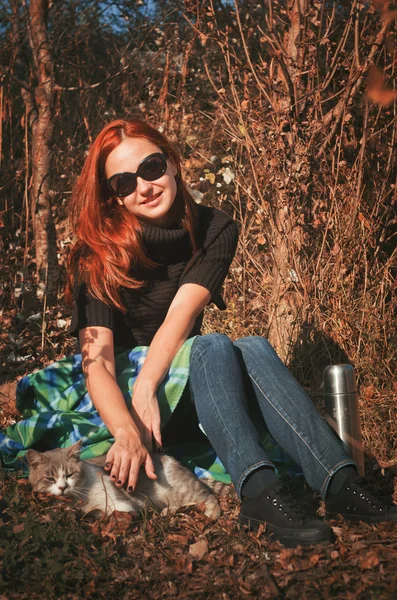 The woman went out for a walk in the park with a cat — Stock Image The woman went out for a walk in the park with a cat Stock Image