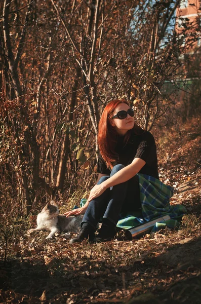 The woman went out for a walk in the park with a cat — Stock Image The woman went out for a walk in the park with a cat Stock Image