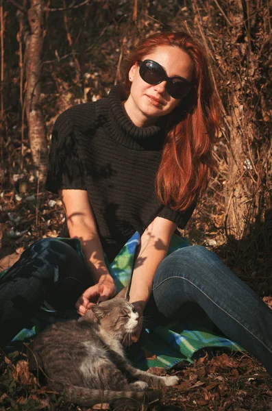 The woman went out for a walk in the park with a cat — Stock Image The woman went out for a walk in the park with a cat Royalty Free Stock Photos