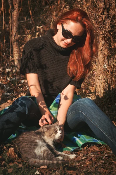 The woman went out for a walk in the park with a cat — Stock Image The woman went out for a walk in the park with a cat Royalty Free Stock Images