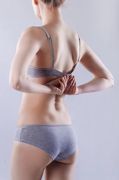 Slim woman in gray underwear — Stock Photo, Image