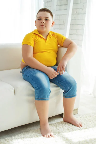 A boy with metabolic disorders. Child with the problem of childhood obesity. Overweight obese fat boy.