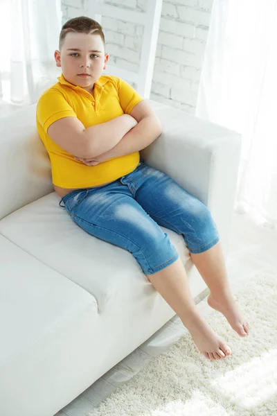 A boy with metabolic disorders. Child with the problem of childhood obesity. Overweight obese fat boy.