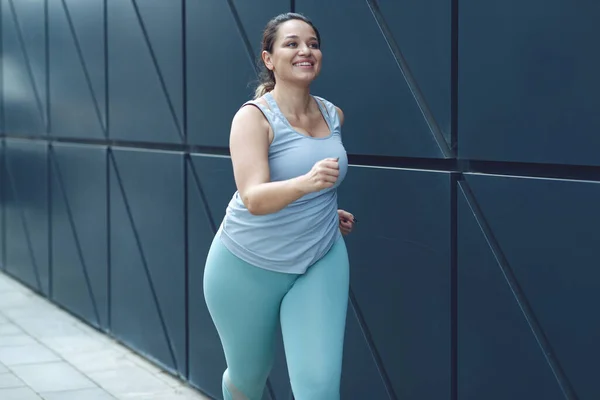Şişman kadın koşuyor, kilo vermek için spor yapıyor, obezite problemi var..