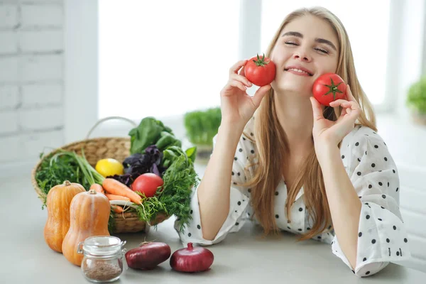 Gyönyörű fiatal nő zöldséget eszik a konyhában. Egészséges étel. Vega saláta. Fogyókúra. Diétás fogalom. Egészséges életmód. Főzz otthon.. — Stock Fotó