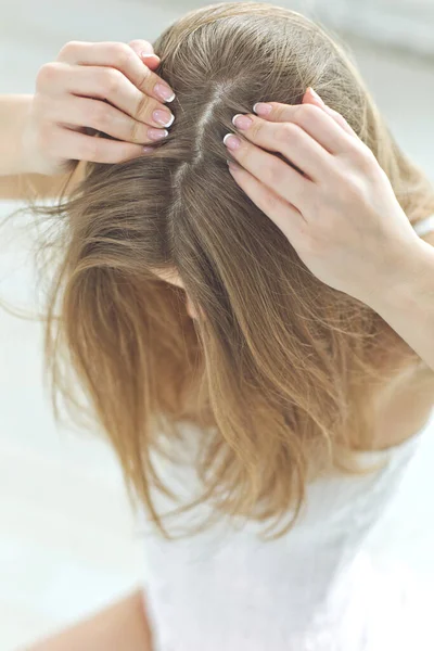 Young woman with hair loss problem on white background, closeup. Woman hair problem.