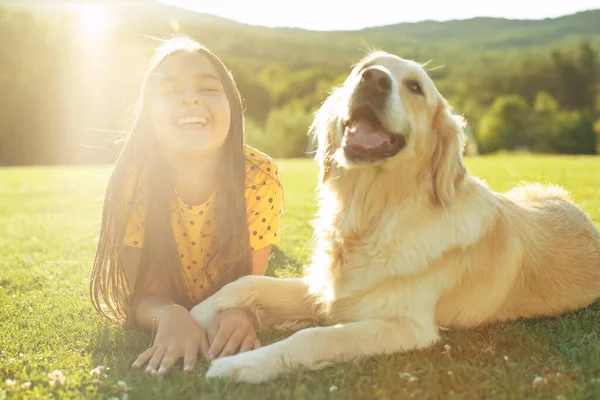 A child with a dog. A child plays with a dog in nature. — Stock Photo, Image