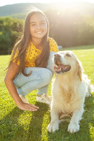 A child with a dog. A child plays with a dog in nature. — Stock Photo, Image