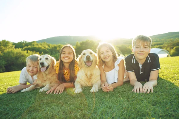 Children play with a dog in nature. — Stock Photo, Image