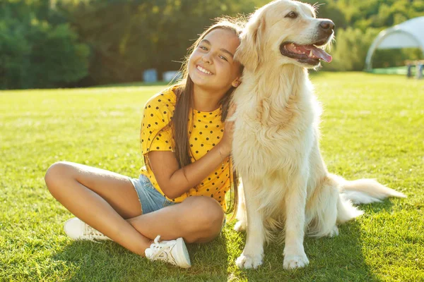A child with a dog. A child plays with a dog in nature. — Stock Photo, Image