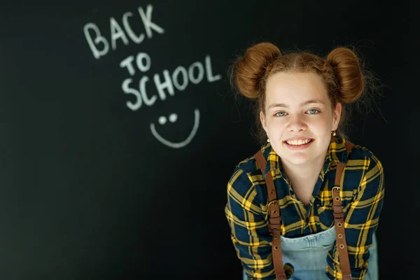 Boldog mosolygós lány. Gyerek a táblánál. Lány beltéri tanterem krétával a háttérben. Visszamegyünk az iskolába.. — Stock Fotó