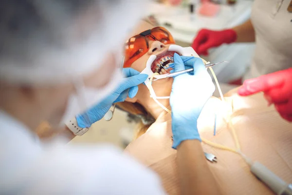 Adolescente con l'apparecchio da visita all'ortodontista della clinica. Installazione del sistema di supporto. — Foto Stock