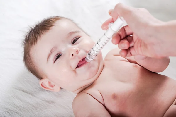 Doctor gives some medicine to a little baby. — Stock Photo, Image