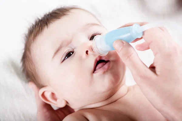 Doctor cleans the nose of little baby. — Stock Photo, Image