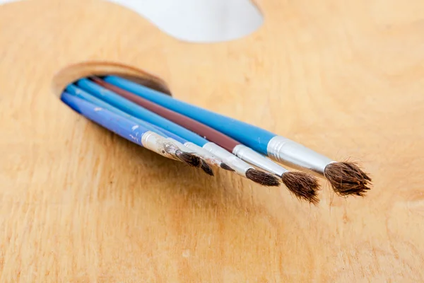 Paintbrushes on palette. — Stock Photo, Image