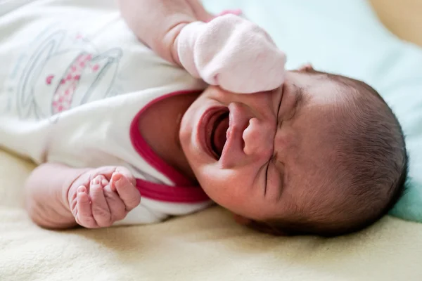 Beautiful crying newborn baby.