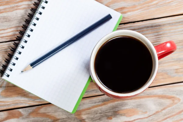 Coffee cup with notebook — Stock Photo, Image