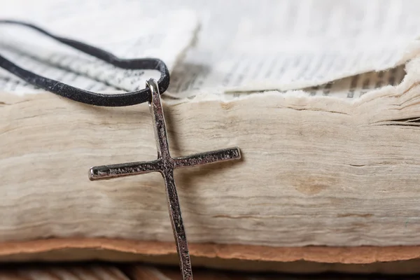 Old silver christian cross on bible — Stock Photo, Image