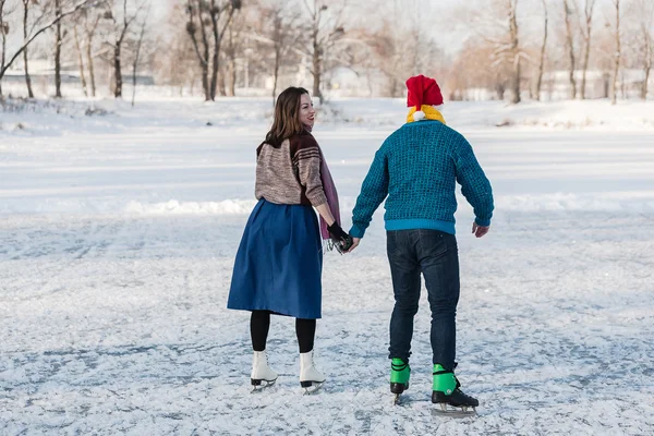 Happy couple having fun ice skating on rink outdoors. — Stock Photo, Image