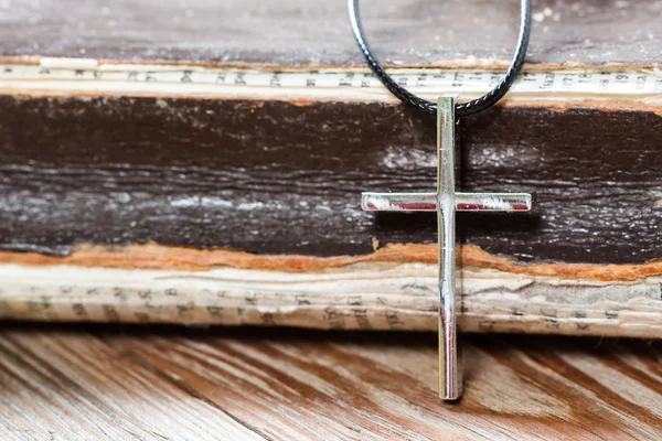 Silver Christian cross on bible — Stock Photo, Image