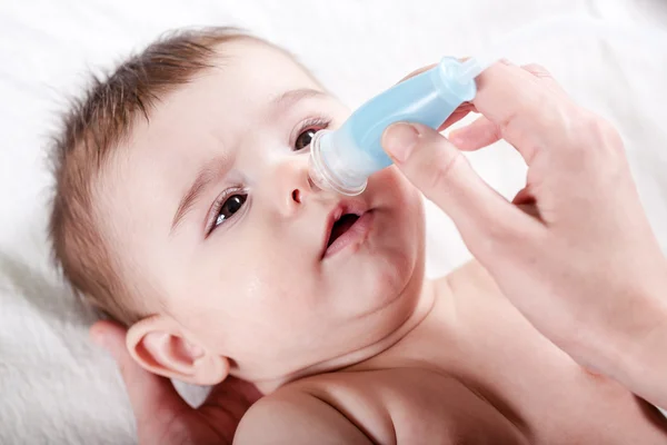 Doctor cleans the nose of little baby. — Stock Photo, Image