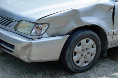 a scared marks on a front-left car body from accidentally hit by fast drive motorcycle, show broken mirror of flashlight cover 
