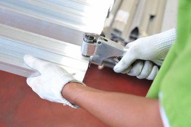 a worker use a mesurement tool with finish steel work