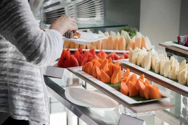 a people pickup some fruit at food conner for lunch