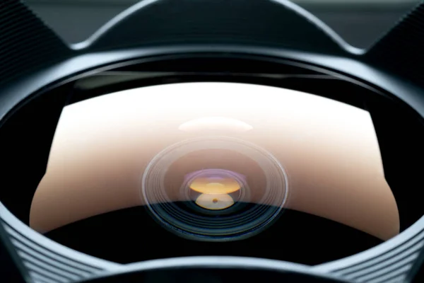 close up shot of lens surface  with reflection of light box with narrow focusing and partly blur