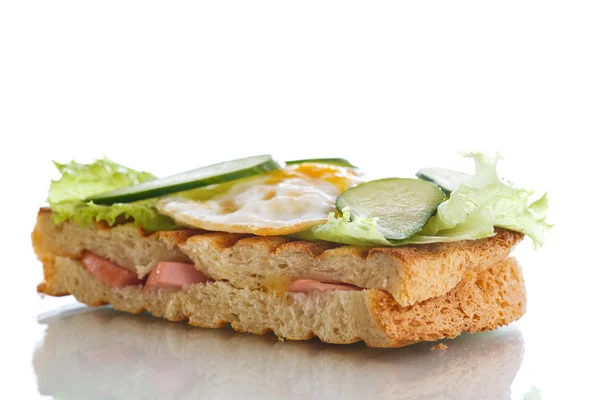 Sandwich with sausage, cheese, lettuce and eggs — Stock Photo, Image