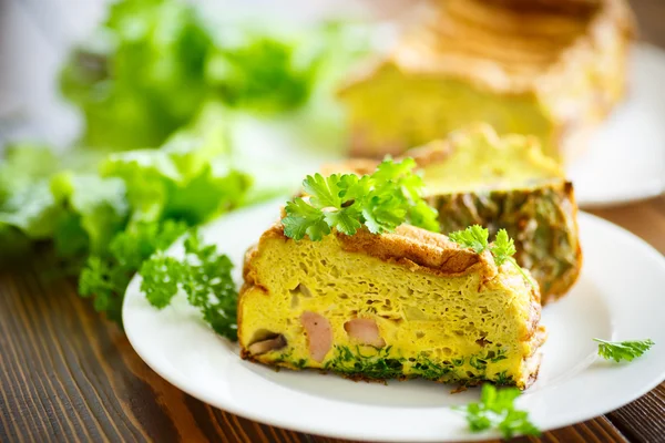 Baked omelette with sausages and greens — Stock Photo, Image