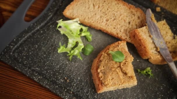 Homemade meat pate with bread on a wooden table — Stock Video