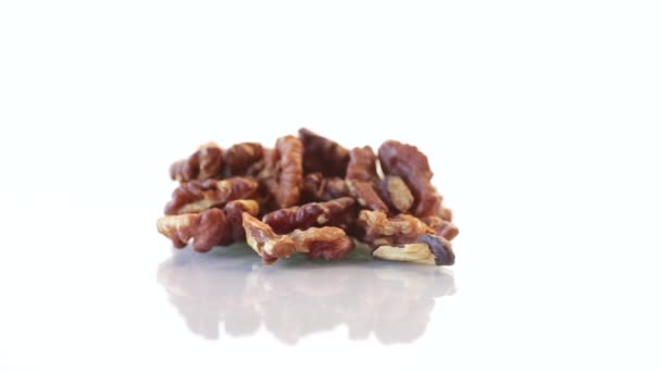 Handful of peeled walnuts on white background — Stock Video