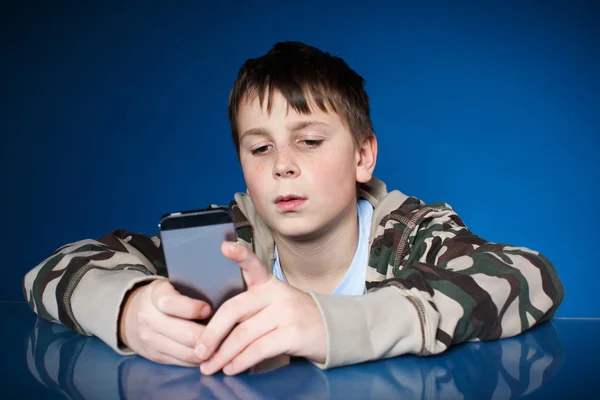 Teenage boy with phone in hand — Stock Photo, Image