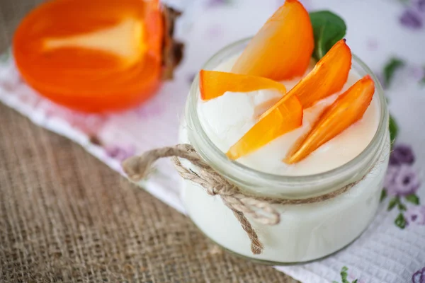 Sweet homemade yogurt with persimmons — Stock Photo, Image