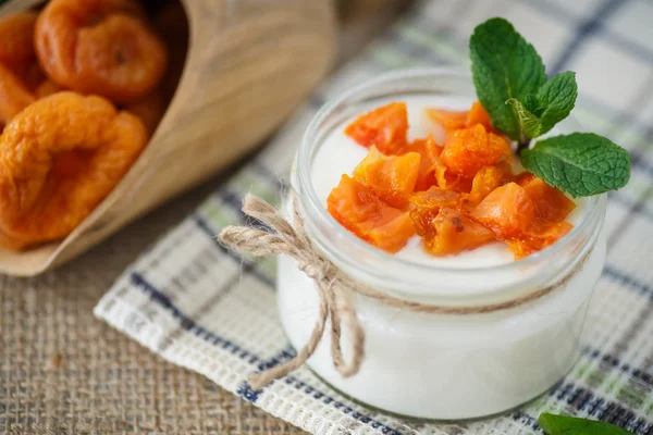 Sweet homemade yogurt with dried apricots — Stock Photo, Image
