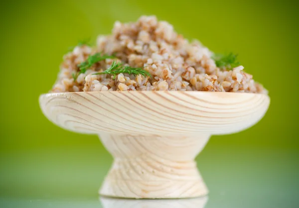 Boiled buckwheat in a wooden bowl — Stock Photo, Image