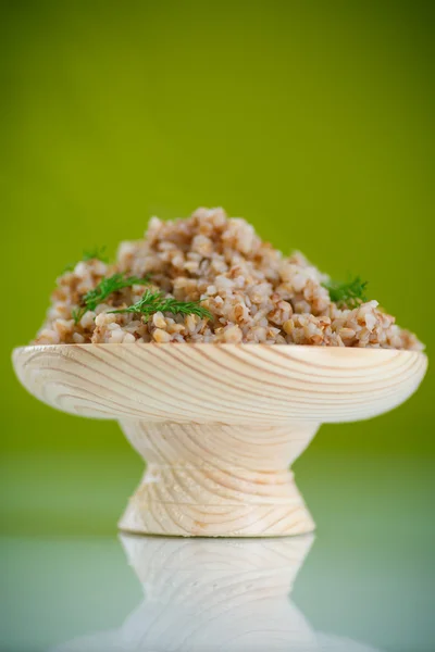 Boiled buckwheat in a wooden bowl — Stock Photo, Image