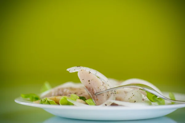 Pieces of salted herring with onions — Stock Photo, Image