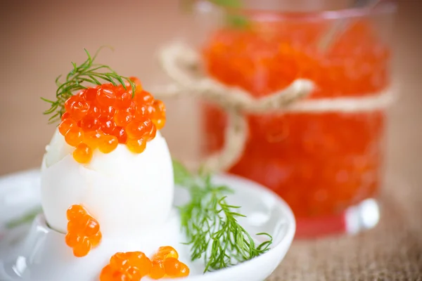 Boiled egg with red caviar — Stock Photo, Image